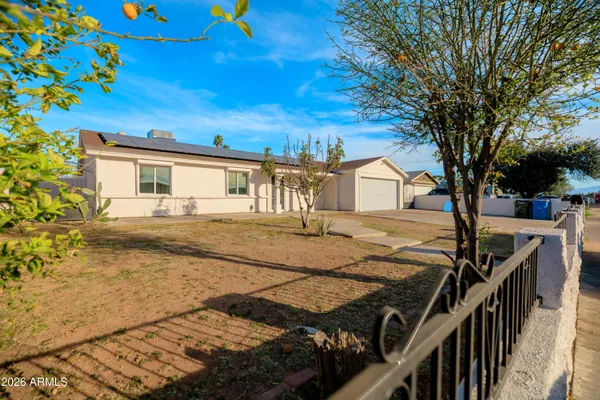 a view of house with backyard and trees