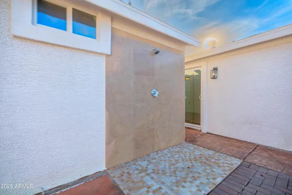 a bathroom with a shower and a sink