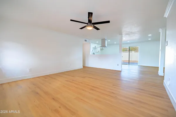 a view of empty room with wooden floor