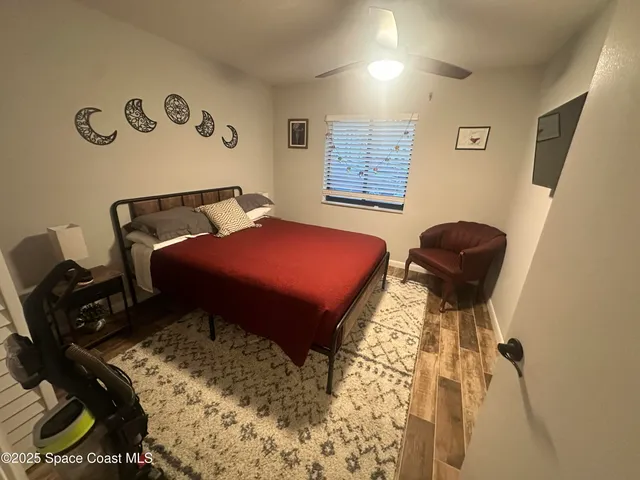 a bed room with a bed and a chair