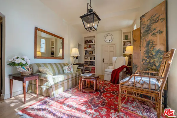 a living room with furniture a rug and a chandelier