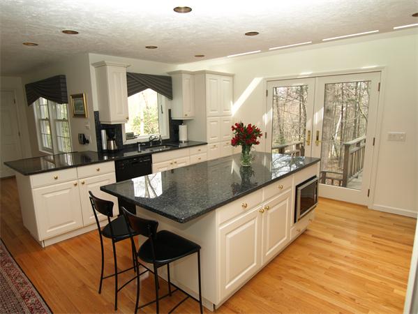 108 West Berlin Road Bolton, MA 01740 - Photo 6 of 25 a large kitchen with kitchen island granite countertop a counter top space and stainless steel appliances