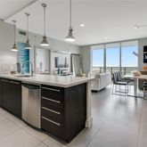 a kitchen with a sink counter top space and living room view