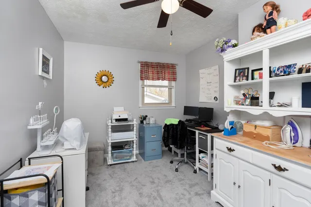 a view of a workspace with furniture and toys