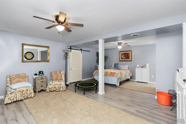 a bedroom with furniture and wooden floor
