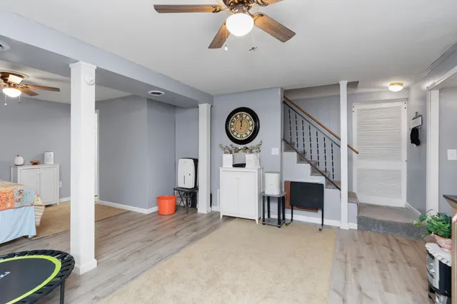 a view of a hallway to a livingroom with furniture
