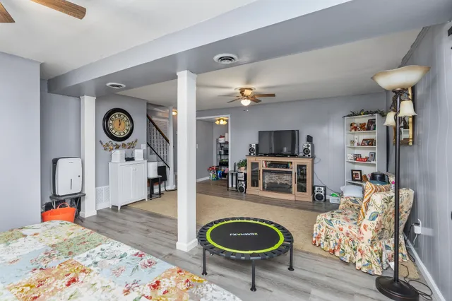 a living room with furniture and a wooden floor