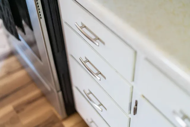 a view of staircase with railing and white walls
