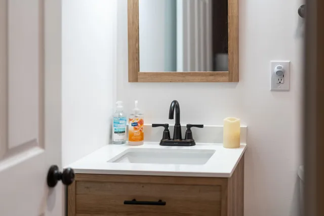 a bathroom with a sink and a mirror