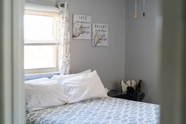 a bedroom with a bed and a window