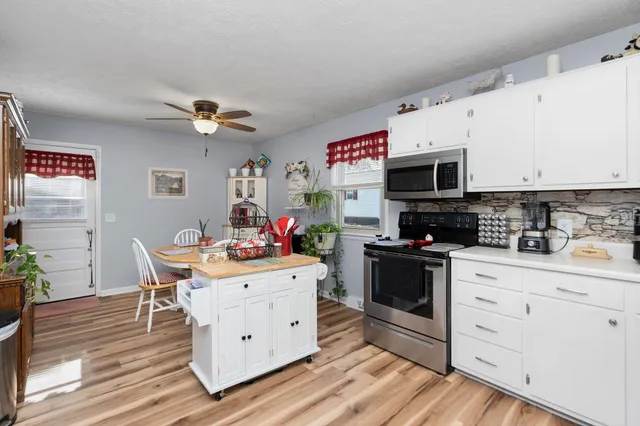 a kitchen with a sink cabinets and wooden floor