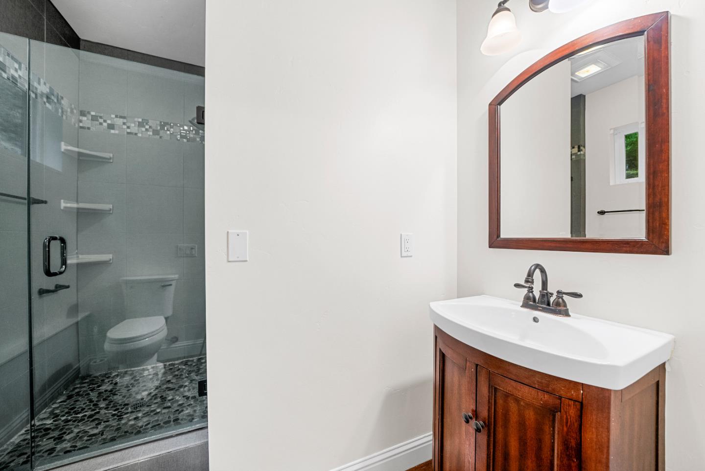 Undisclosed Address Boulder Creek, CA 95006 - Photo 30 of 41 a bathroom with a sink a toilet and a mirror