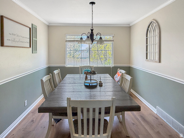 1716 Sagewood Road Price, UT 84501 - Photo 8 of 73 Dining room featuring hanging lights, wood finished floors, and crown molding