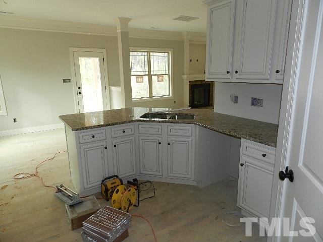 430 Fieldtrial Circle Garner, NC 27529 - Photo 4 of 23 a kitchen with granite countertop a sink cabinets and window