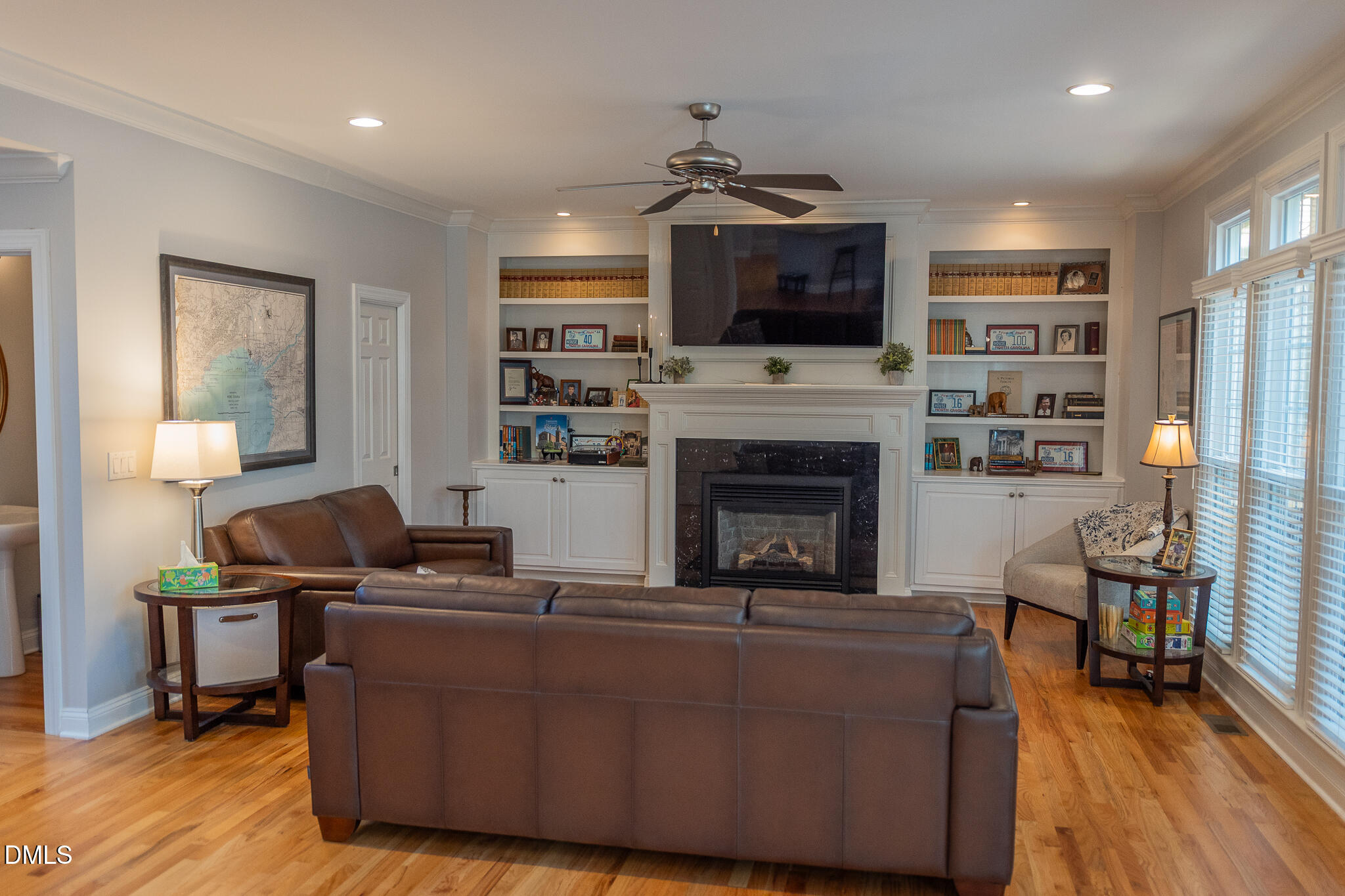 12324 Canolder Street Raleigh, NC 27614 - Photo 14 of 64 a living room with furniture a flat screen tv and a fireplace