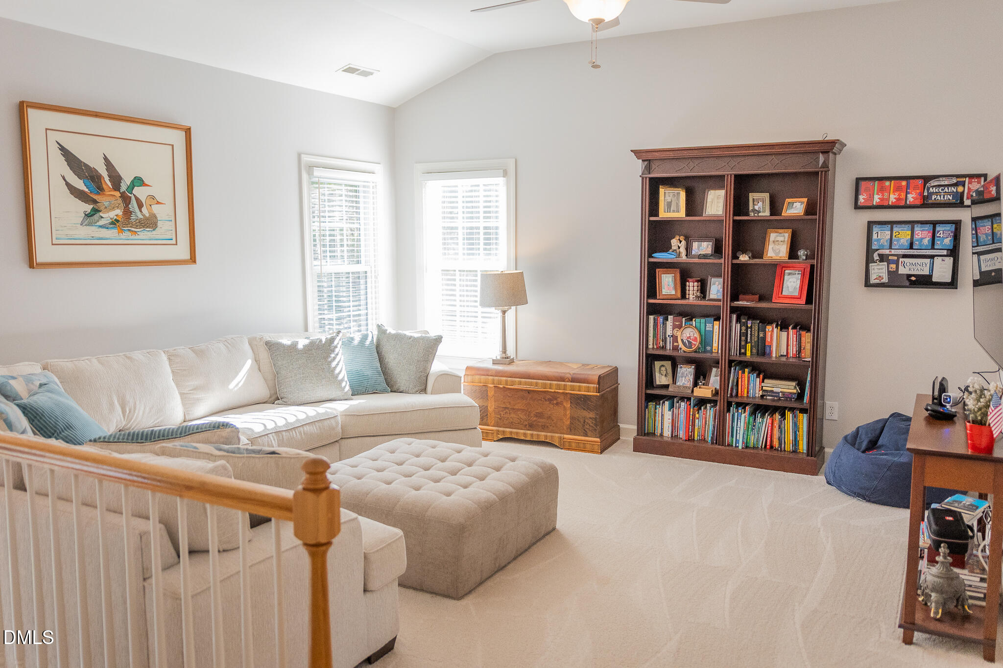 12324 Canolder Street Raleigh, NC 27614 - Photo 33 of 64 a living room with furniture cabinets and a book shelf