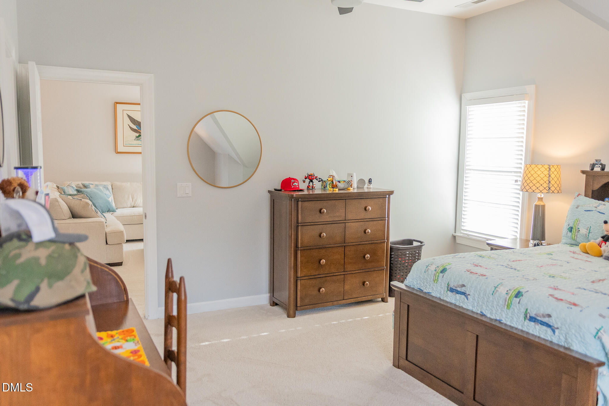 12324 Canolder Street Raleigh, NC 27614 - Photo 36 of 64 a bedroom with a bed and a chandelier