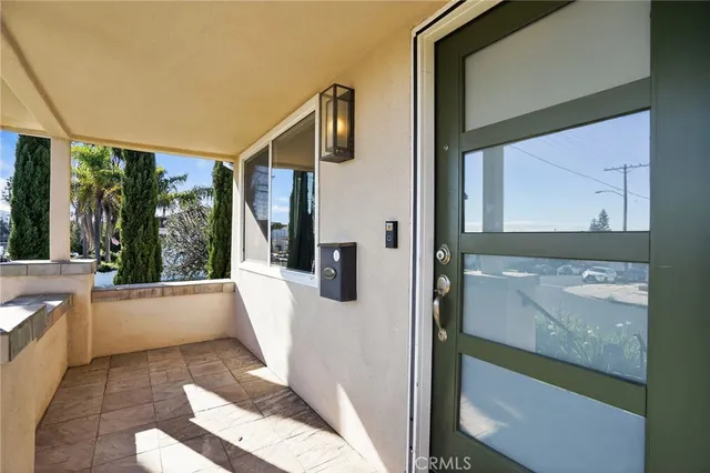 an empty room with wooden floor a ceiling fan and windows