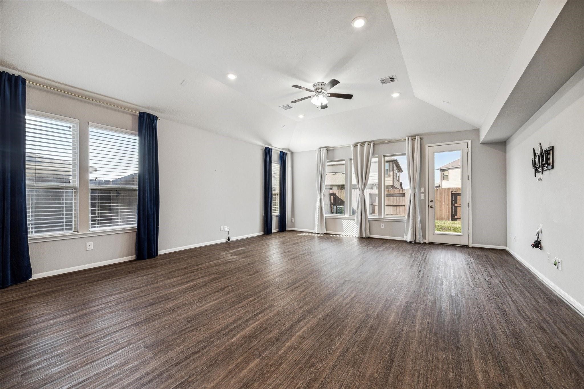 14019 Harmony Ridge Trail Pearland, TX 77584 - Photo 2 of 10 a view of an empty room with a window and wooden floor
