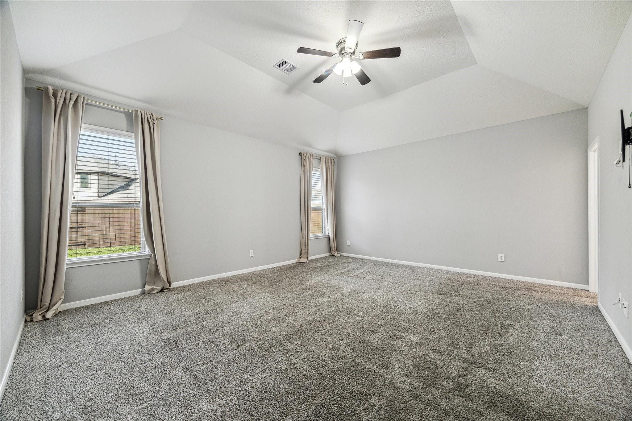 14019 Harmony Ridge Trail Pearland, TX 77584 - Photo 3 of 10 an empty room with chandelier fan and windows
