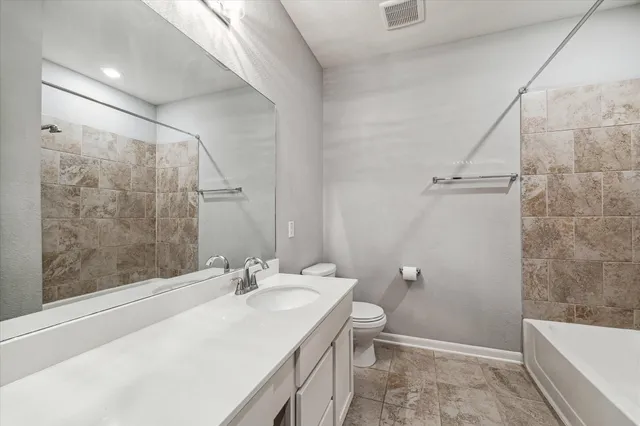 an empty room with closet and windows