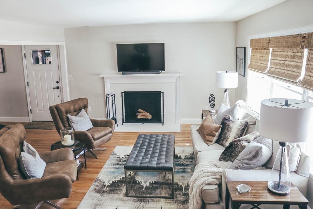 26 Nutting Road Groton, MA 01450 - Photo 5 of 18 a living room with furniture a flat screen tv and a fireplace