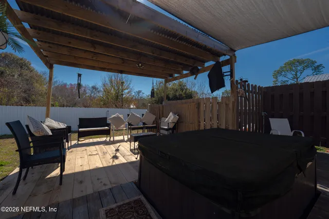 a backyard of a house with table and chairs