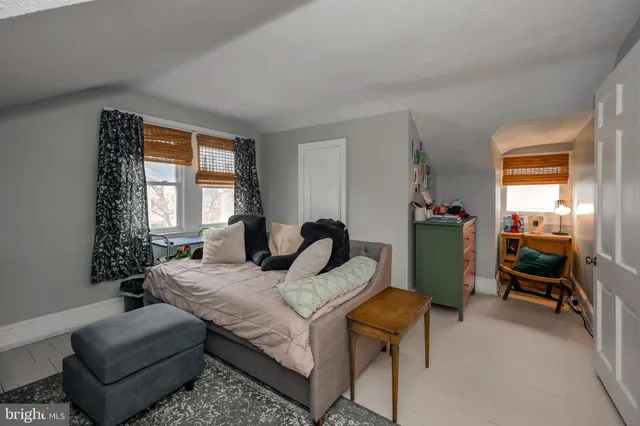 a bedroom with a bed and a chair