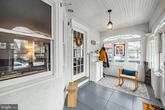 a living room with furniture and a painting on the wall