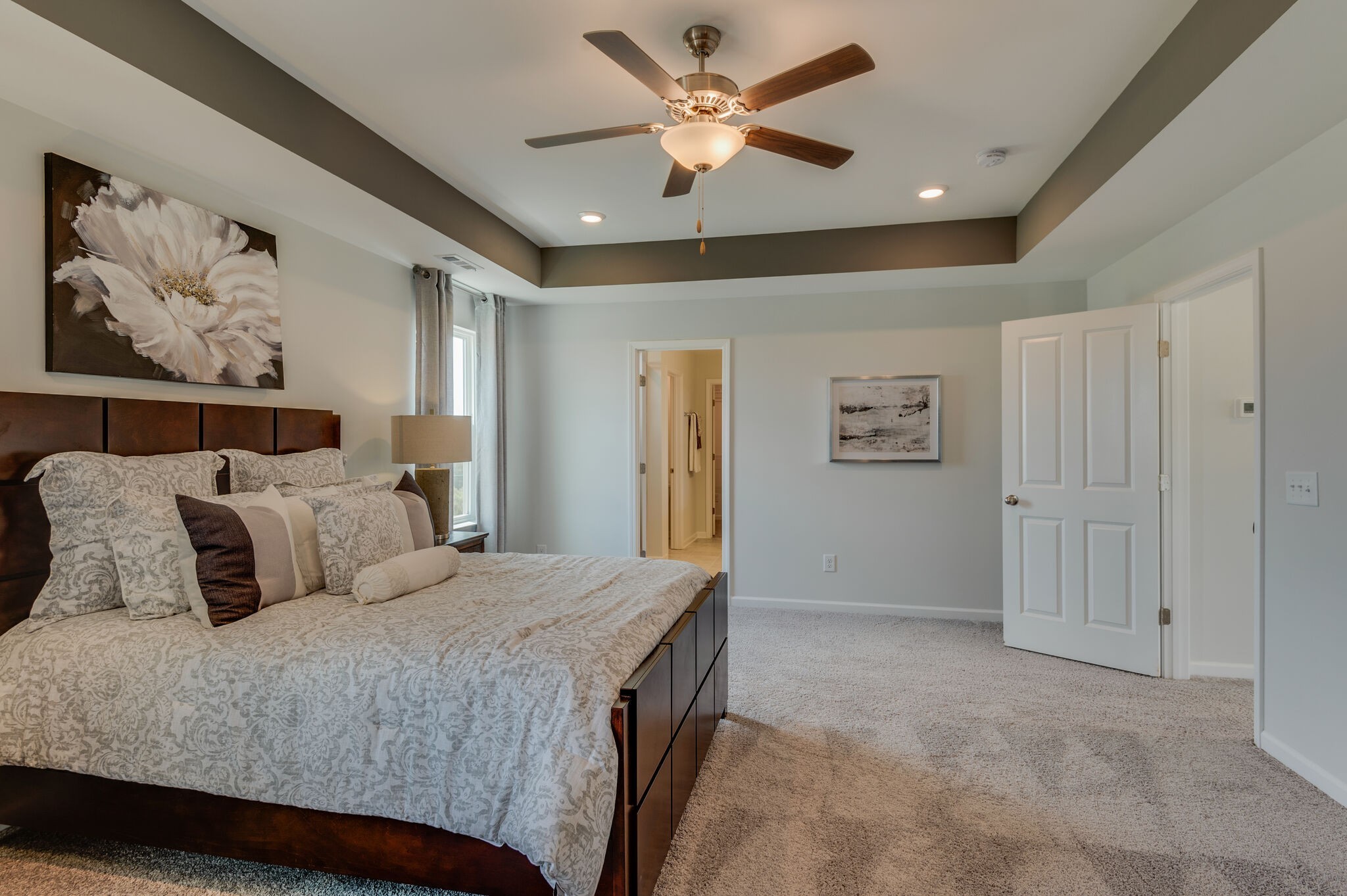 611 Castle Road Mount Juliet, TN 37122 - Photo 20 of 30 a bedroom with a large bed and a chandelier