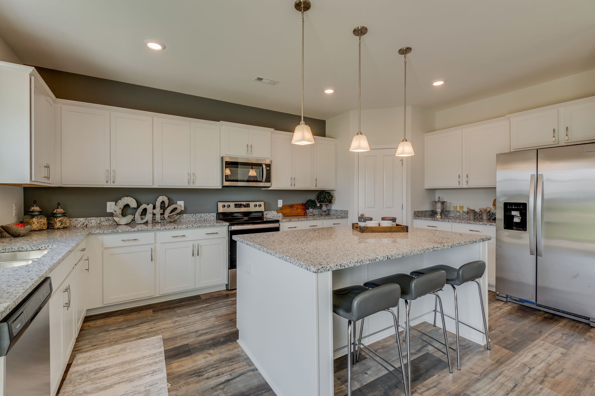 611 Castle Road Mount Juliet, TN 37122 - Photo 9 of 30 a kitchen with stainless steel appliances granite countertop a sink a stove a refrigerator and island with wooden floor