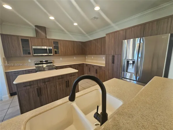 a bathroom with a sink and glass door shower