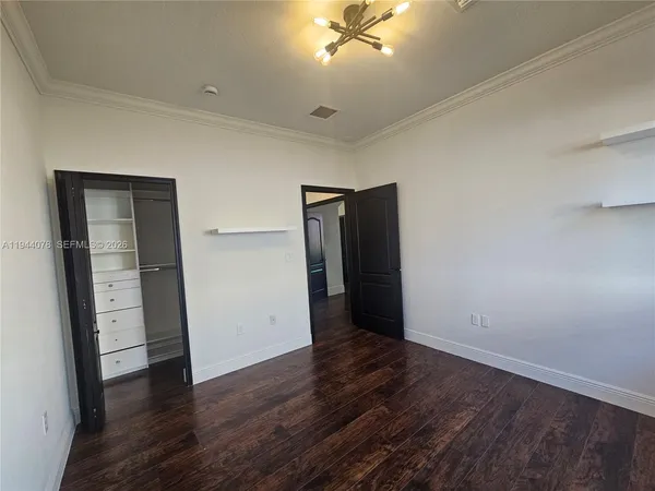 a view of walk in closet with empty racks