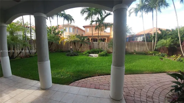 a front view of a house with plants