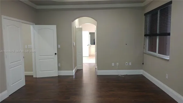 a view of walk in closet with wooden floor