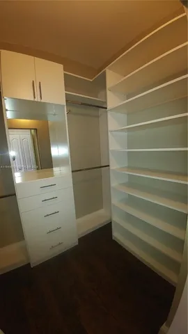 a spacious bathroom with a double vanity sink a mirror and a bathtub