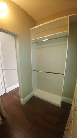 a bathroom with a double vanity sink toilet and shower