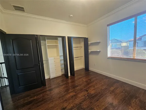 a view of a house with a yard and potted plants