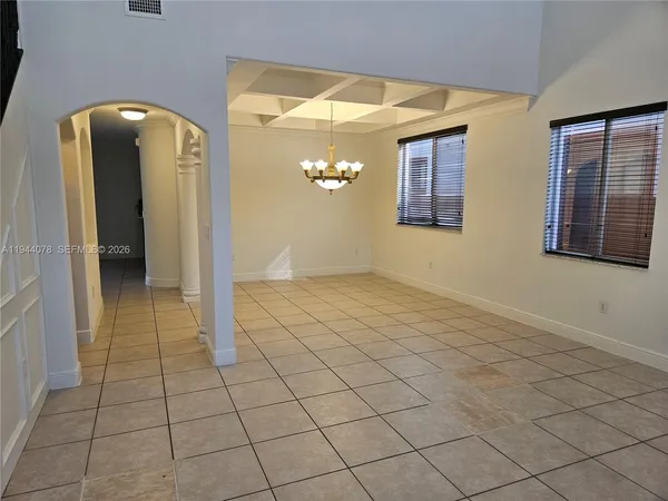 a view of a hallway with chandelier