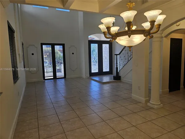 a kitchen with stainless steel appliances kitchen island granite countertop a refrigerator and a stove top oven