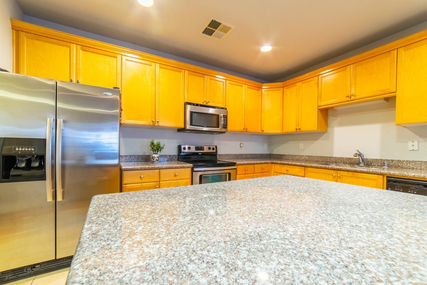 88 North Jackson Avenue, Unit 127 San Jose, CA 95116 - Photo 5 of 10 a kitchen with stainless steel appliances granite countertop a sink a stove and a refrigerator