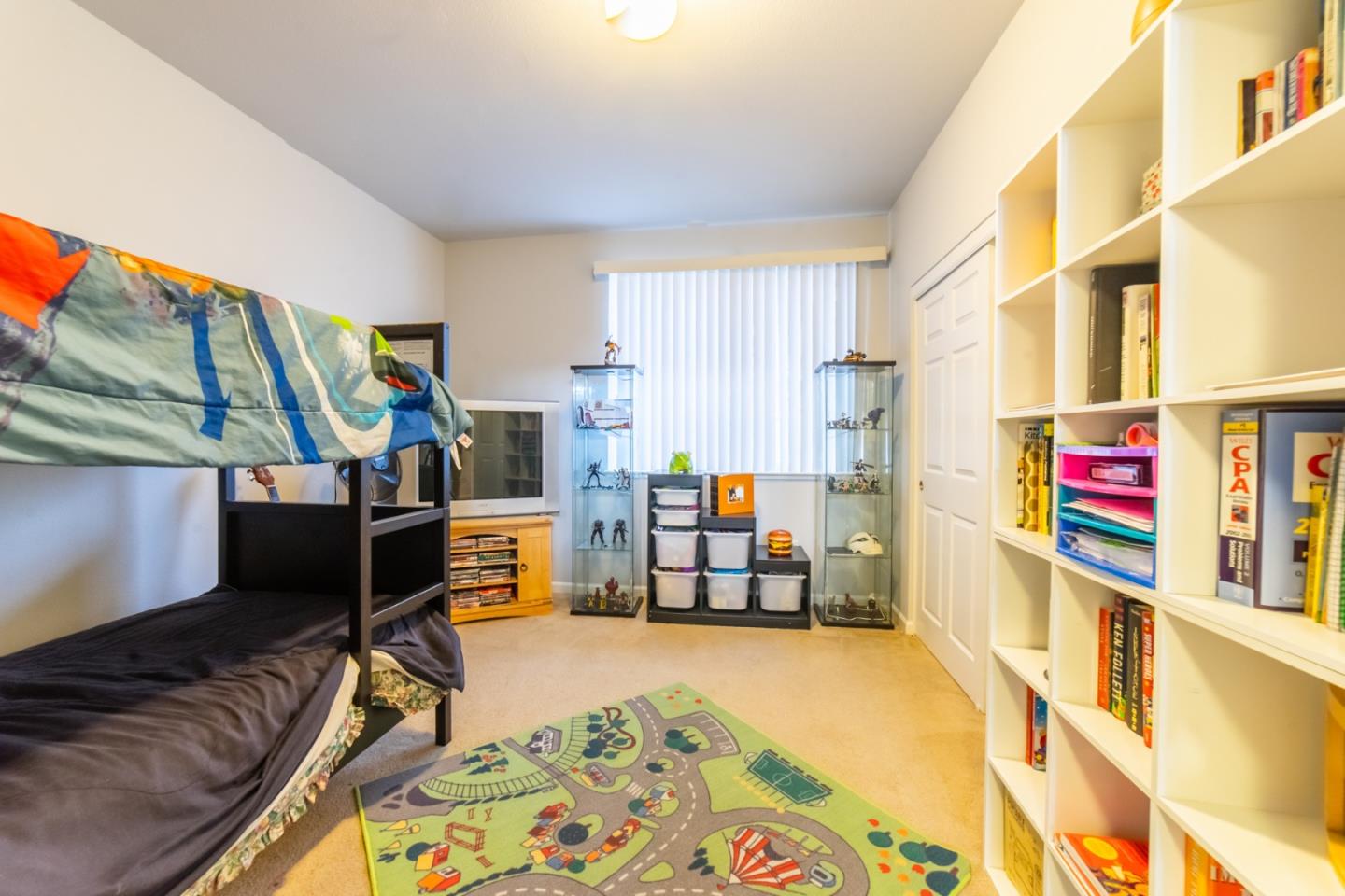88 North Jackson Avenue, Unit 127 San Jose, CA 95116 - Photo 6 of 10 a living room with furniture and a book shelf