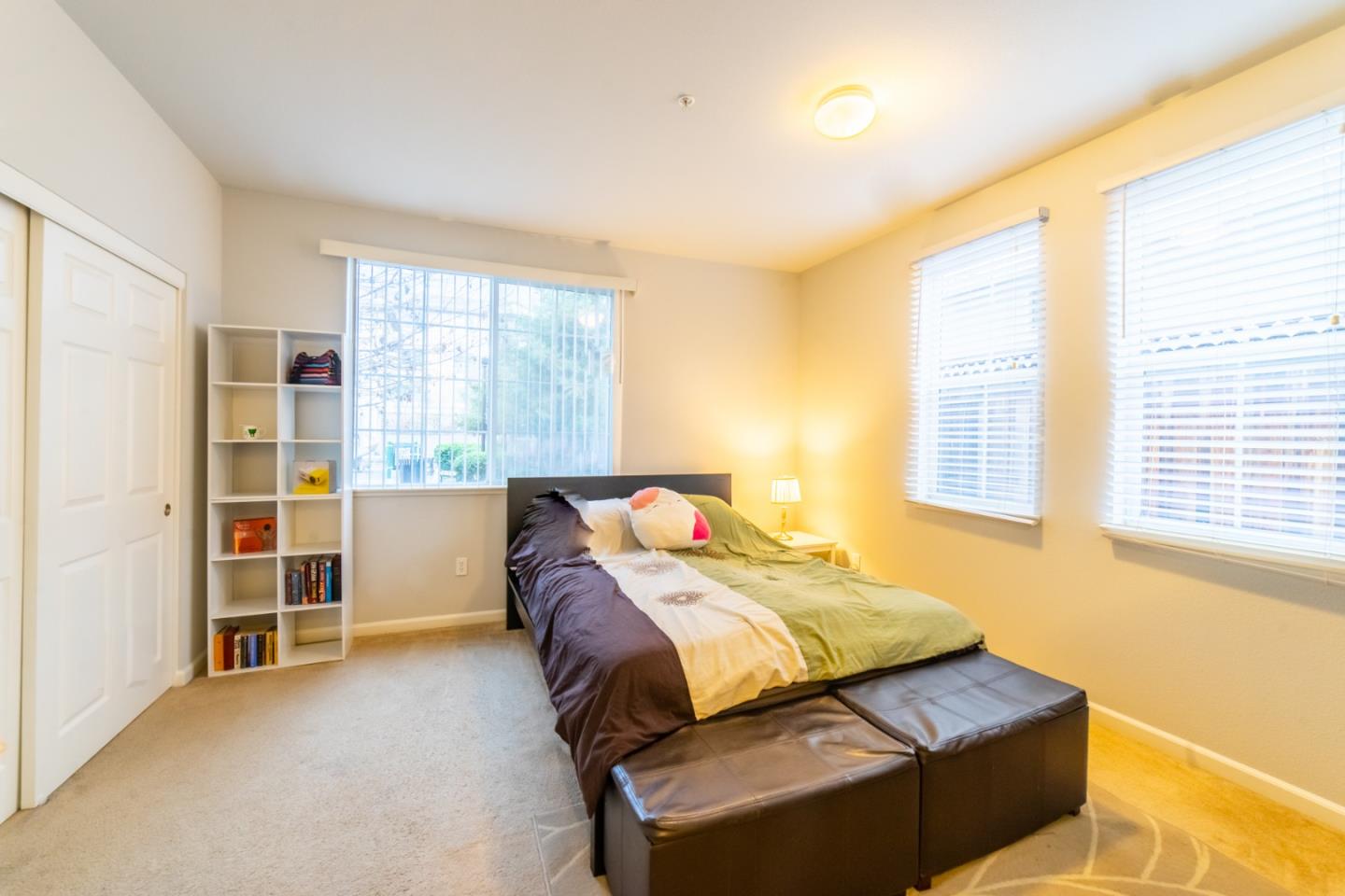 88 North Jackson Avenue, Unit 127 San Jose, CA 95116 - Photo 8 of 10 a bedroom with a bed and a cabinets