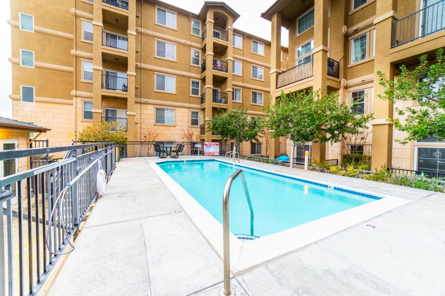 88 North Jackson Avenue, Unit 127 San Jose, CA 95116 - Photo 10 of 10 a view of a building with a swimming pool