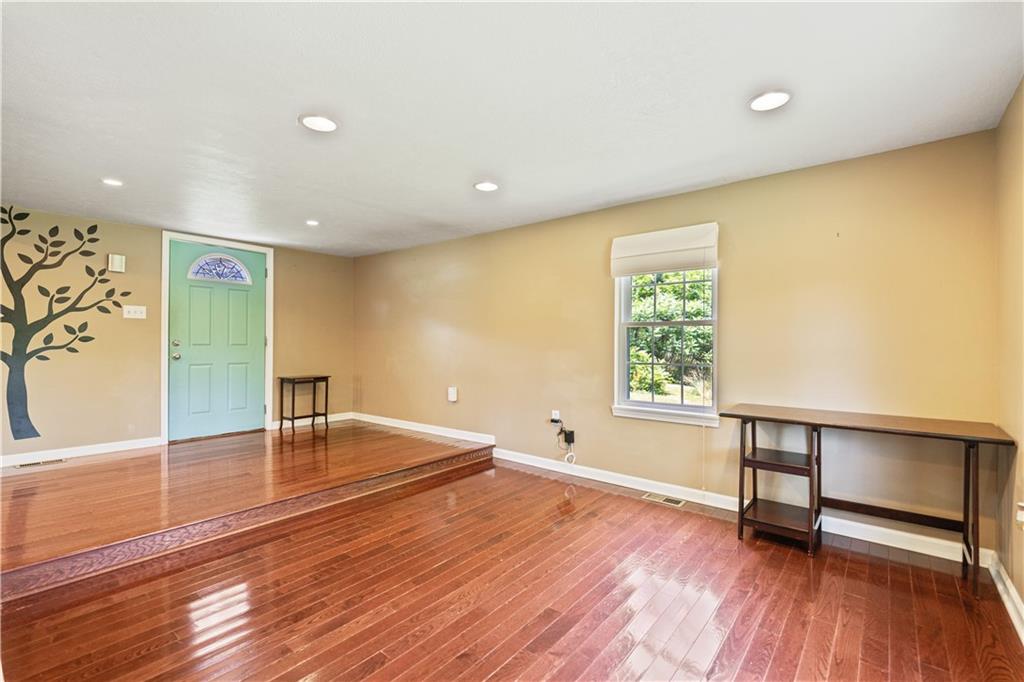 815 Arbor Ln Mount Mount Pleasant, PA 15666 - Photo 13 of 25 wooden floor in an empty room with a window
