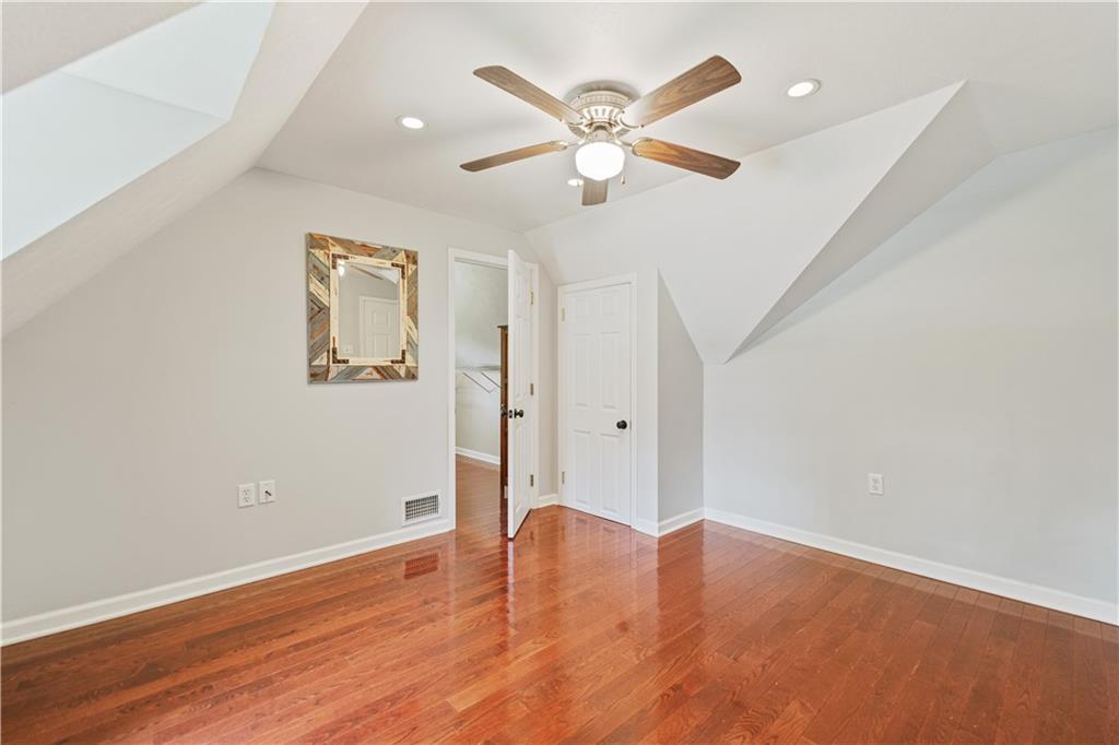 815 Arbor Ln Mount Mount Pleasant, PA 15666 - Photo 17 of 25 an empty room with wooden floor and windows