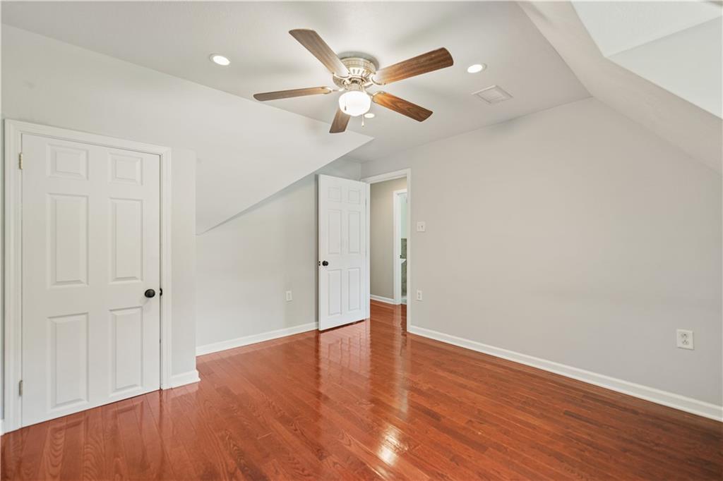 815 Arbor Ln Mount Mount Pleasant, PA 15666 - Photo 18 of 25 an empty room with wooden floor and ceiling fan