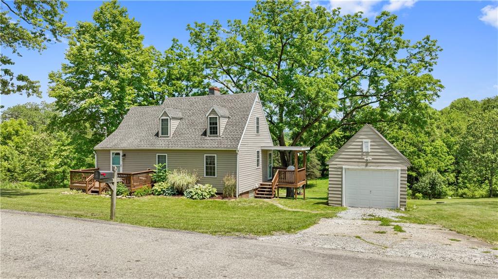 815 Arbor Ln Mount Mount Pleasant, PA 15666 - Photo 2 of 25 a front view of a house with a yard and garage