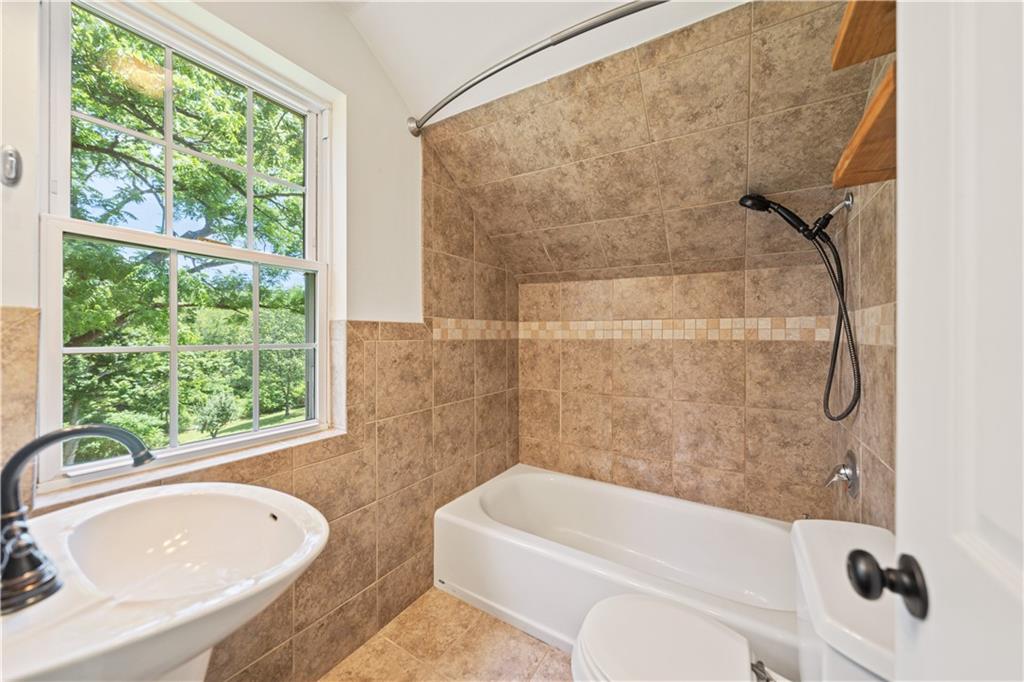 815 Arbor Ln Mount Mount Pleasant, PA 15666 - Photo 21 of 25 a bathroom with a sink a toilet and a bathtub