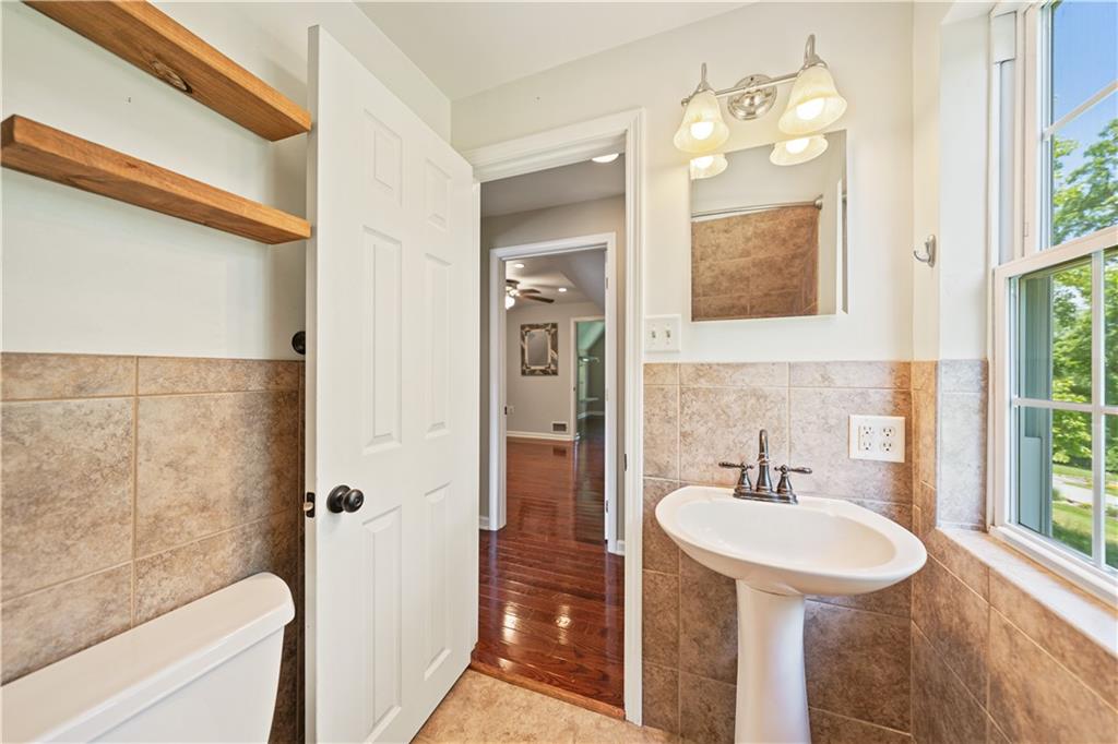 815 Arbor Ln Mount Mount Pleasant, PA 15666 - Photo 22 of 25 a bathroom with a sink and a mirror